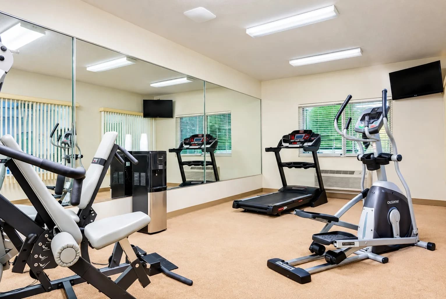Fitness room with a treadmill, elliptical and strength machine