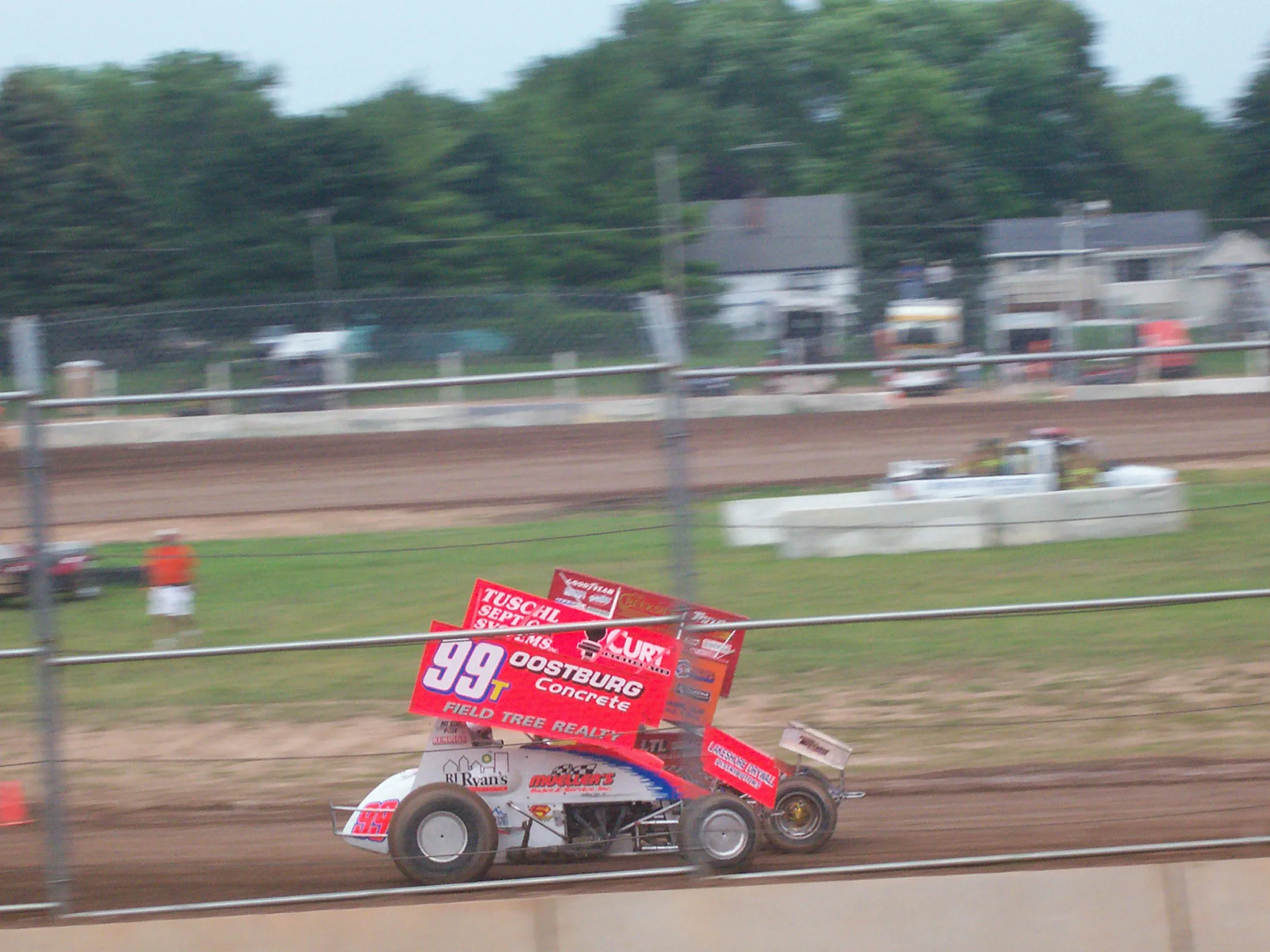 Winged sprint car racing on a dirt oval