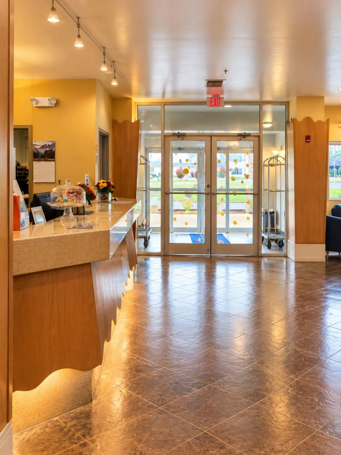 Lobby entrance with the front counter, luggage carts and glass doors